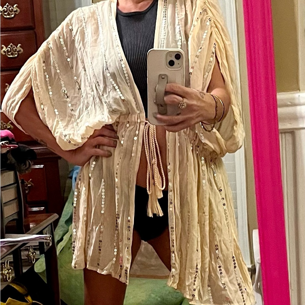 Peach bathing suit coverup with silver sequins.